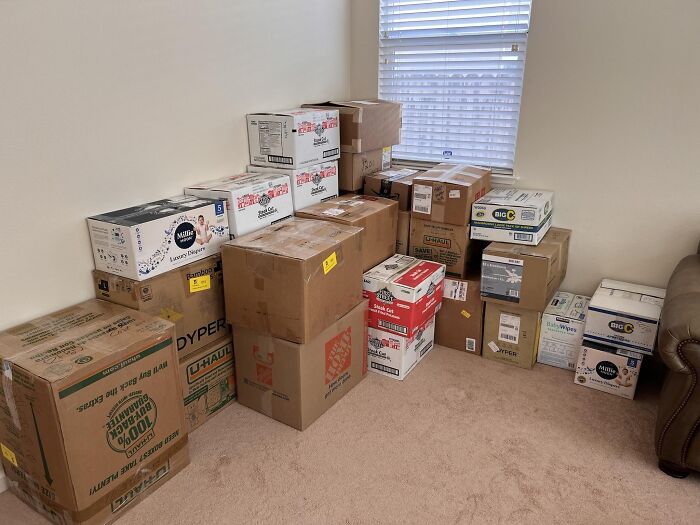 Stack of packed moving boxes in a blank room, showcasing startling home service professionals' client home scenes.
