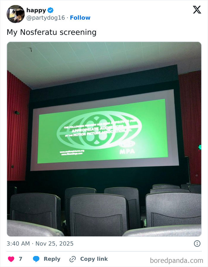 Empty movie theater seats facing a dim screen showing a green motion picture rating, highlighting worst movie theaters.