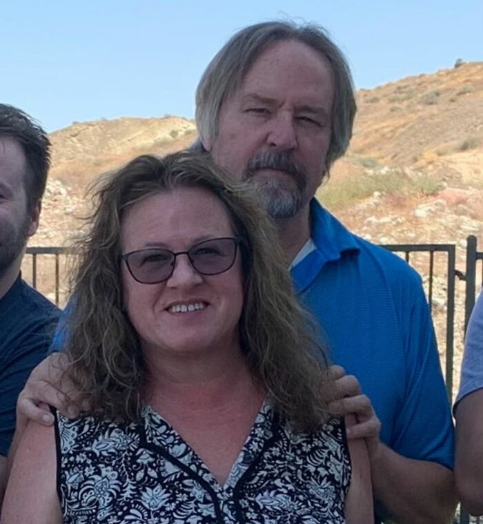 Group of people outdoors with a smiling woman, related to trans Muslim woman&rsquo;s fate after skipping sentencing news.