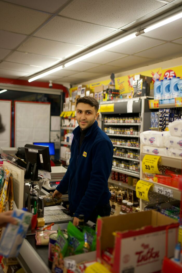 A cashier in a grocery store scanning items, illustrating a glitch in the system being exploited at checkout.