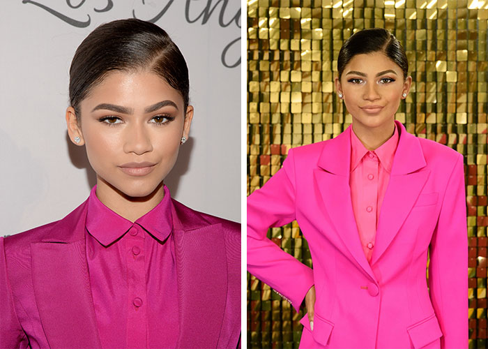 Madame Tussauds wax figure of a celebrity in a bright pink suit posed against a gold tiled backdrop Madame Tussauds wax figure of a celebrity in a bright pink suit posed against a gold tiled backdrop