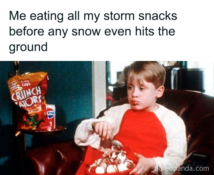 Young boy in a red and white shirt eating snacks on a couch, illustrating funny memes about low energy moments.