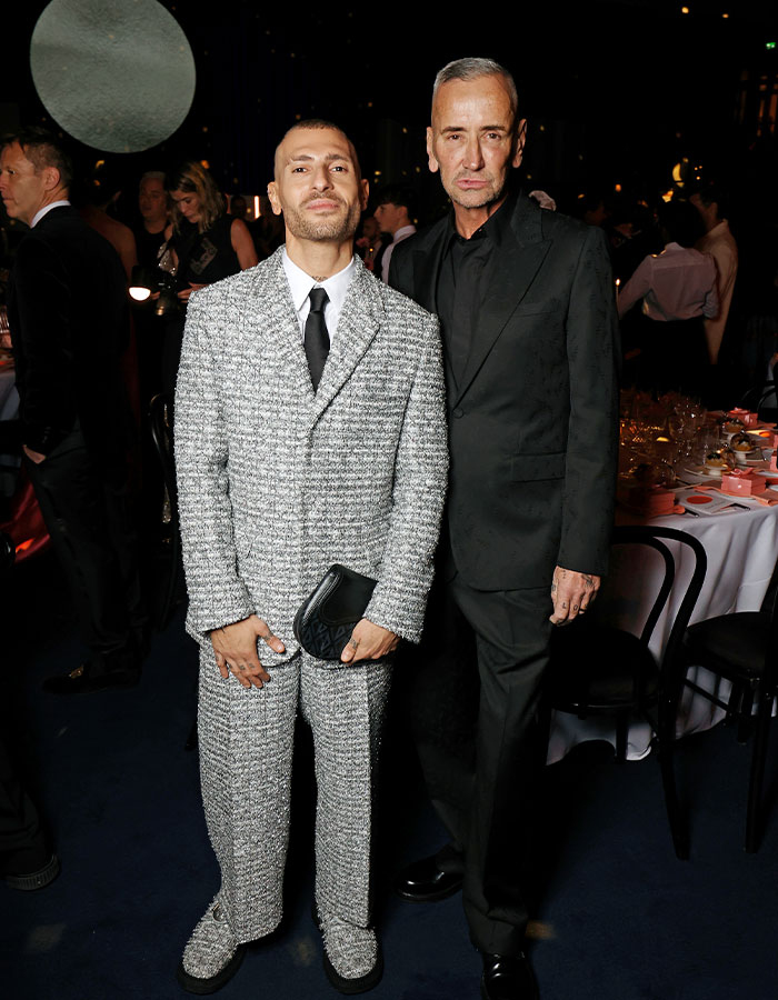 Two men dressed in formal attire at a wedding event revealing new details of Victoria Beckham’s inappropriate dance. Two men dressed in formal attire at a wedding event revealing new details of Victoria Beckham’s inappropriate dance.