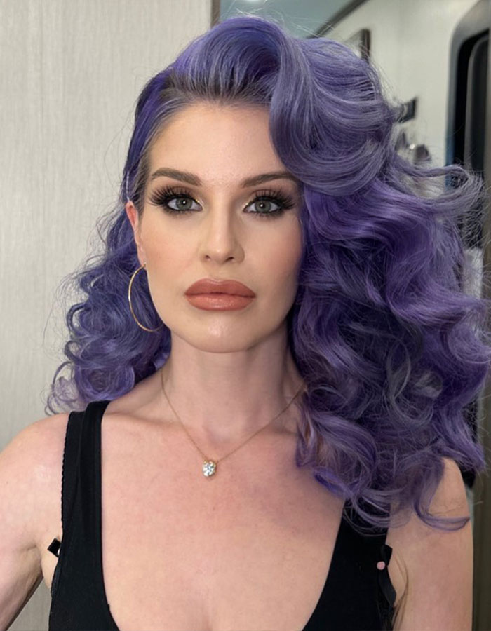 Kelly Osbourne with voluminous purple hair and makeup, fans concerned about her health after recent video. Kelly Osbourne with voluminous purple hair and makeup, fans concerned about her health after recent video.