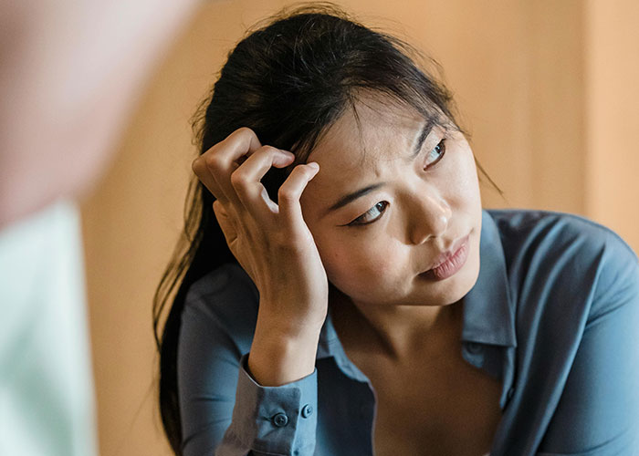 Woman looking distressed and thoughtful during husband’s full-blown tantrum after refusal to follow demands Woman looking distressed and thoughtful during husband’s full-blown tantrum after refusal to follow demands