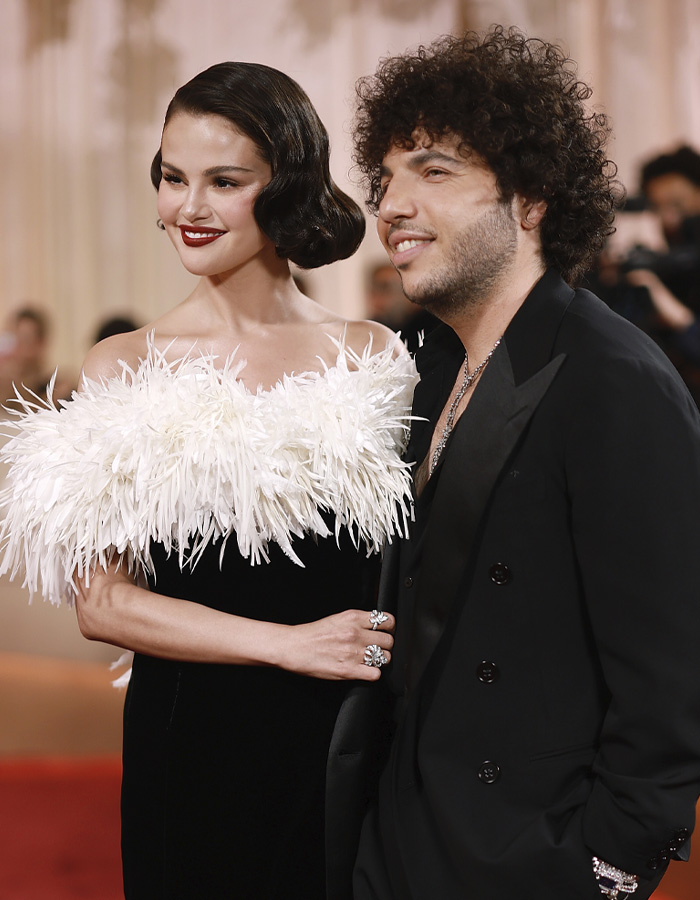 Selena Gomez and Benny Blanco posing together in elegant attire at the Golden Globes, sparking fan reactions and discussions.