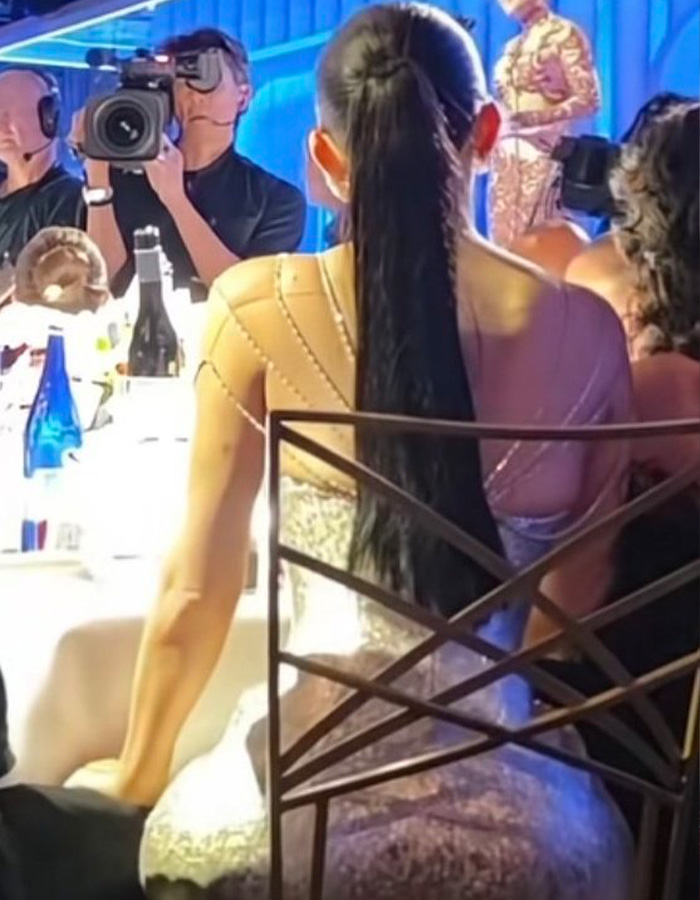 Kylie Jenner sitting in an unusual Golden Globes seat wearing a sparkling dress with a long ponytail at a formal event. Kylie Jenner sitting in an unusual Golden Globes seat wearing a sparkling dress with a long ponytail at a formal event.
