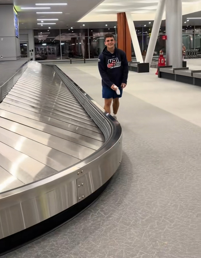 Passenger at baggage claim with underwear appearing one by one on the carousel, creating a viral moment.