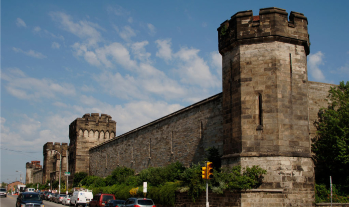 Stone fortress with towers along a busy street, representing one of the most haunted places in America. Stone fortress with towers along a busy street, representing one of the most haunted places in America.