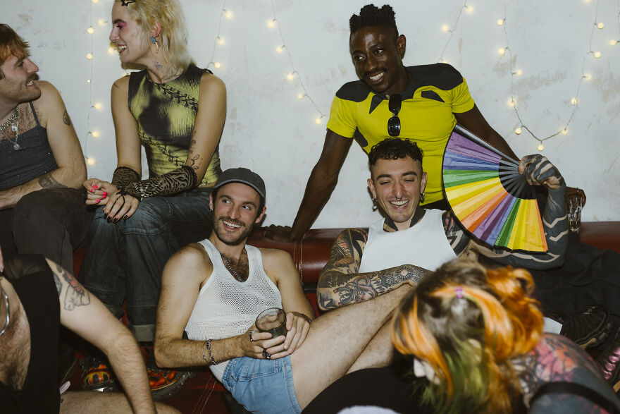 Group of friends laughing and relaxing at a party, engaging in fun paranoia questions and casual conversation. Group of friends laughing and relaxing at a party, engaging in fun paranoia questions and casual conversation.