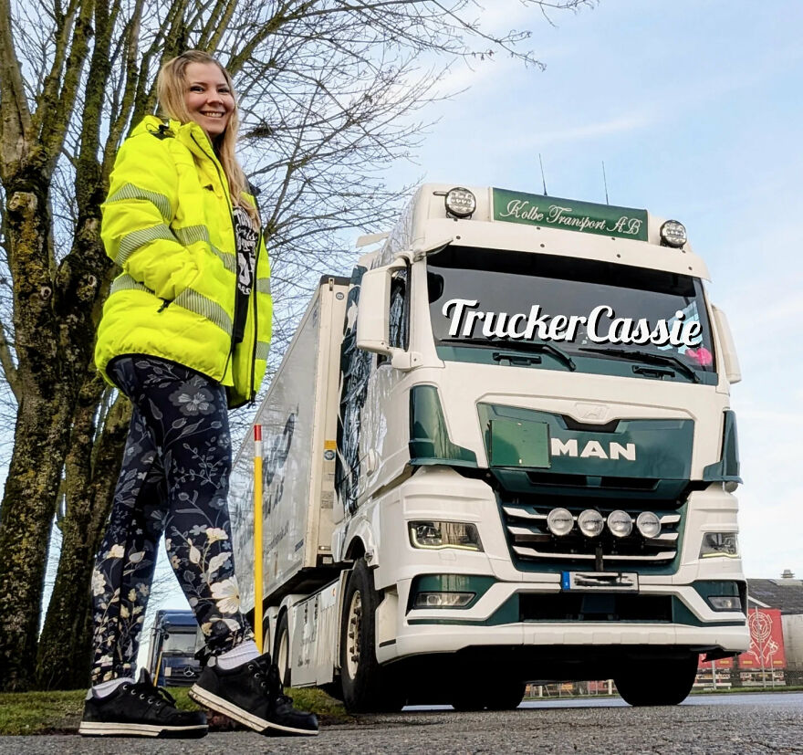 Woman in high-visibility jacket standing next to a large truck, illustrating ultimate work-life balance disasters in trucking jobs.