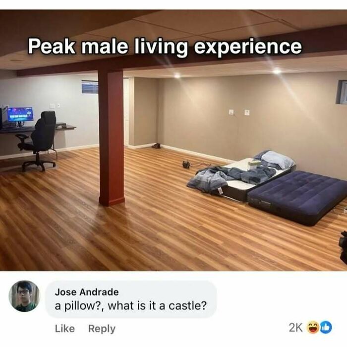 Minimalist room with mattress and computer setup, funny screenshot highlighting peak male living experience humor.