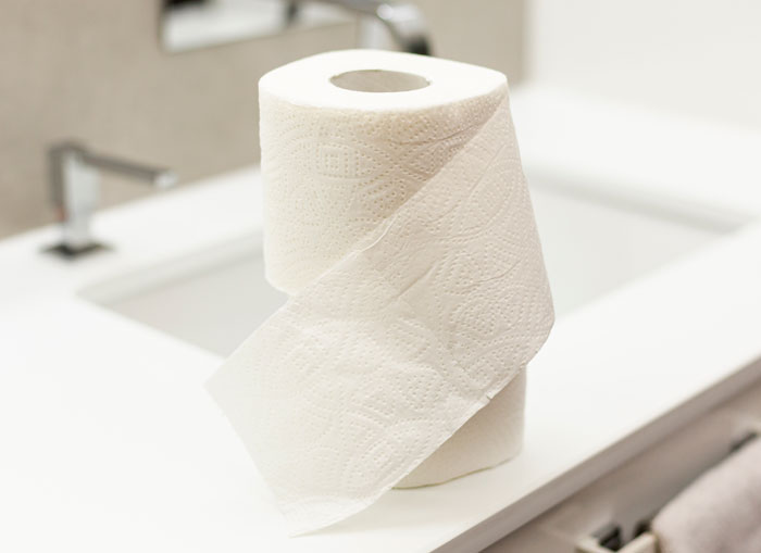 Toilet paper roll on bathroom counter, illustrating friends or family were very weird