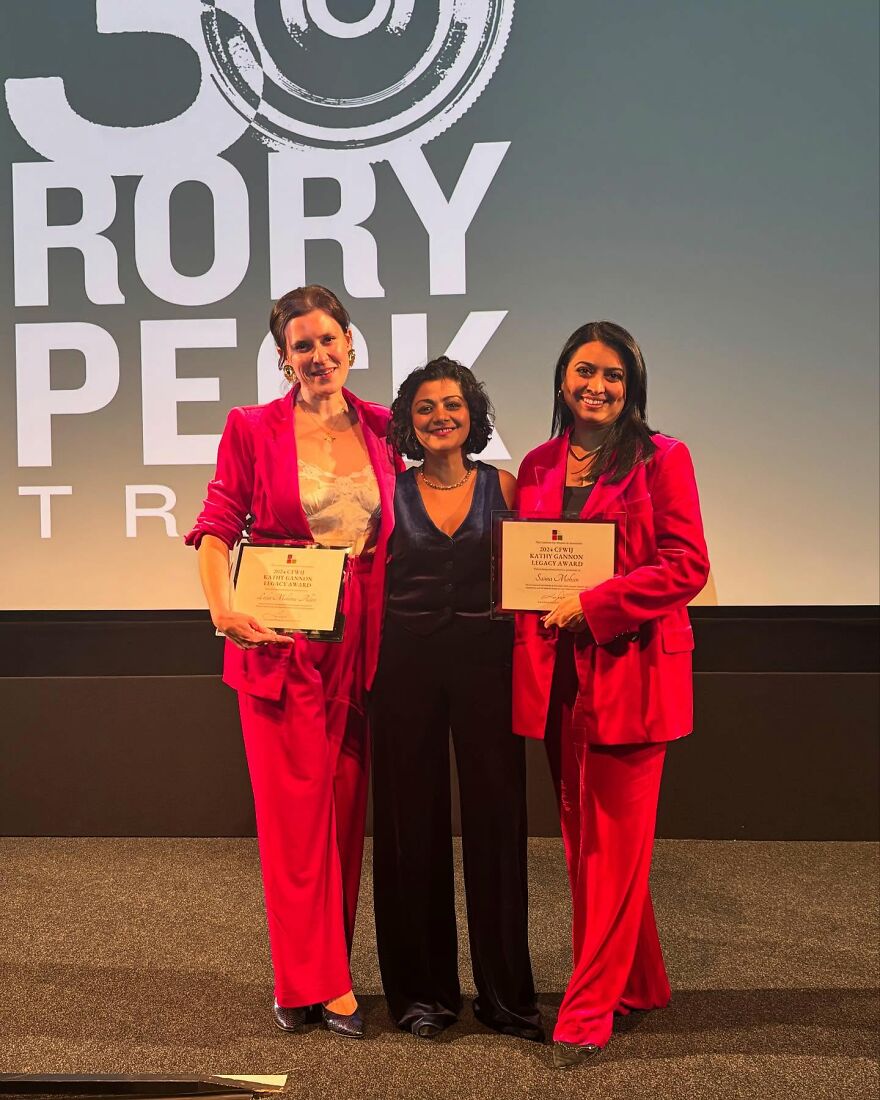 Three professionals holding awards on stage, representing jobs with poor work-life balance challenges.