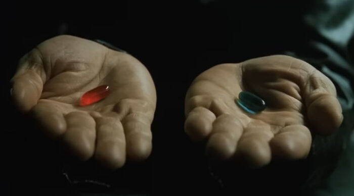 Close-up of two palms holding a red pill and a blue pill, Would You Rather choices visual