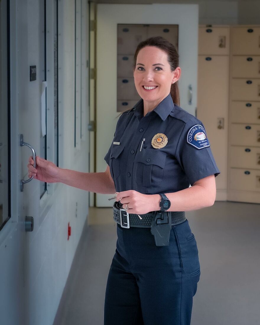 Female police officer in uniform holding a door handle inside a secure facility, representing work-life balance struggles in demanding jobs.