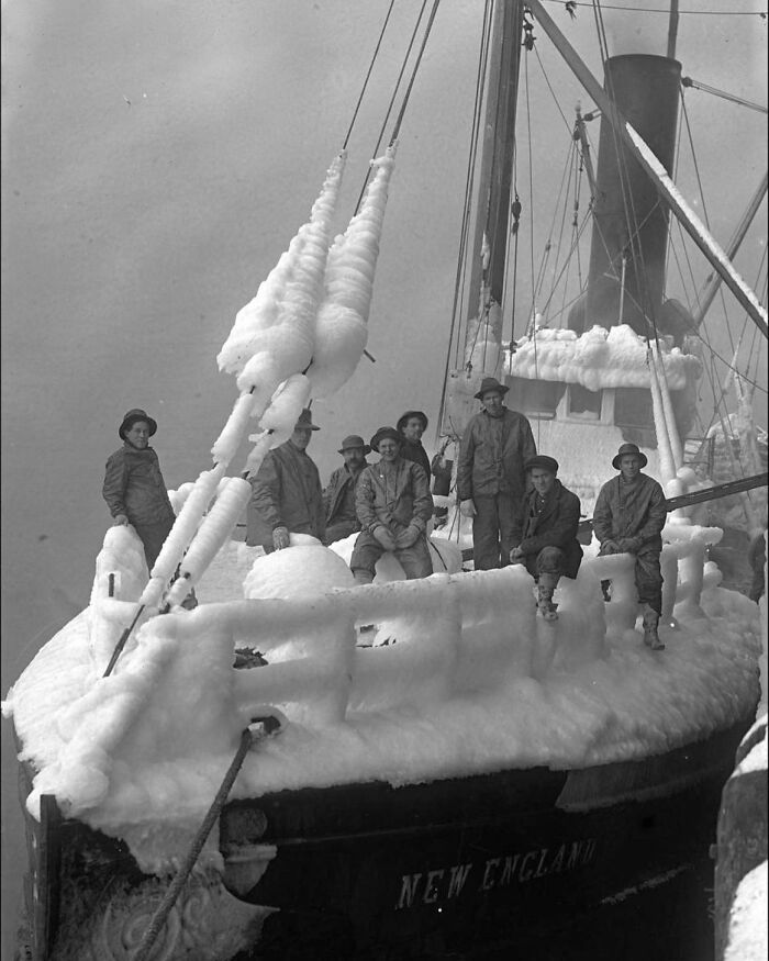 Frozen crew members stand on the icy deck of a ship, illustrating the harsh and dramatic history of humanity’s exploration.