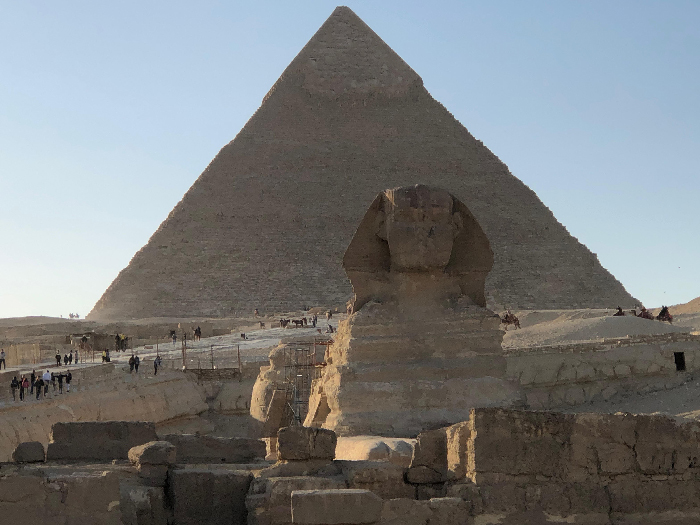 Great Sphinx and Pyramid of Giza with tourists at sunset, photo illustrating Most Stressful Countries travel context