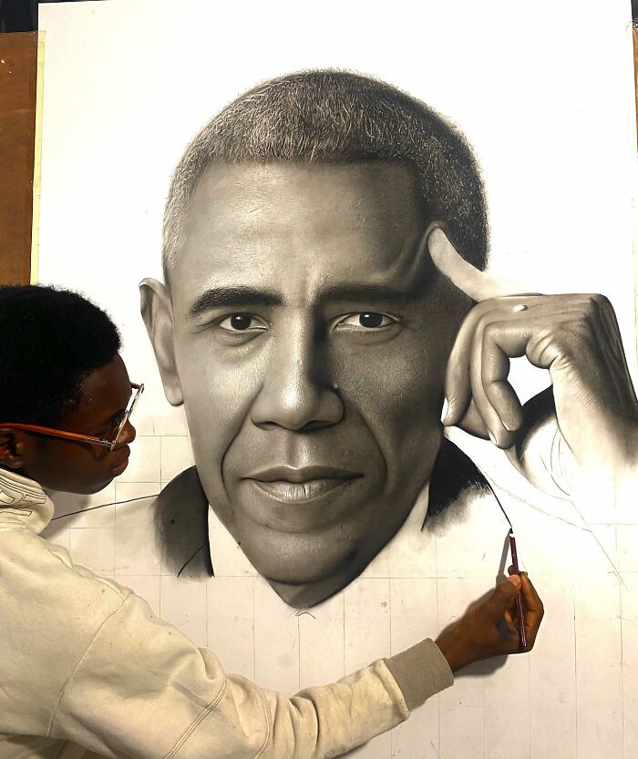 Artist creating a hyperrealistic portrait of a man, focusing on intricate facial details with a fine brush and grid lines.