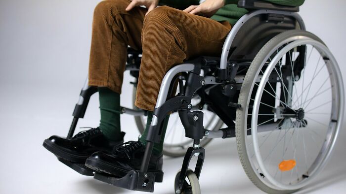 Person in brown pants sitting in a wheelchair, highlighting stories of people who did the right thing.