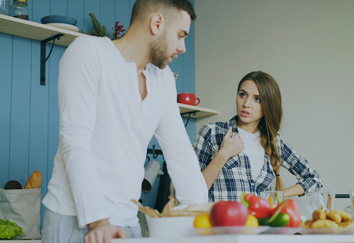Young couple in kitchen having a serious conversation about boyfriend fears golddiggers and cooking expectations. Young couple in kitchen having a serious conversation about boyfriend fears golddiggers and cooking expectations.