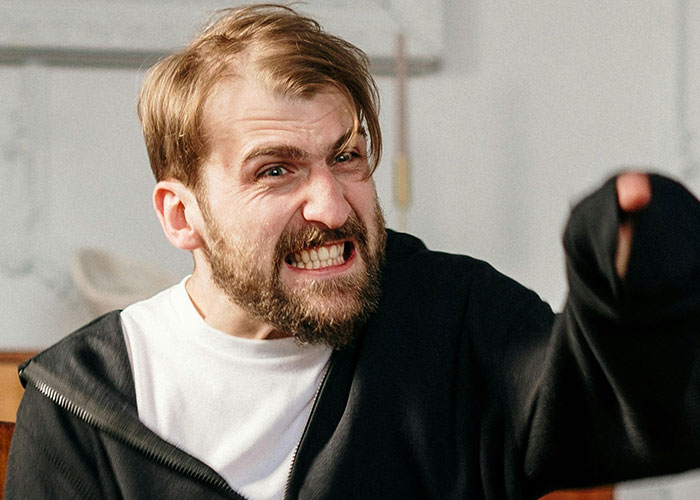 Angry husband throwing a full-blown tantrum indoors, expressing frustration and shouting intensely. Angry husband throwing a full-blown tantrum indoors, expressing frustration and shouting intensely.