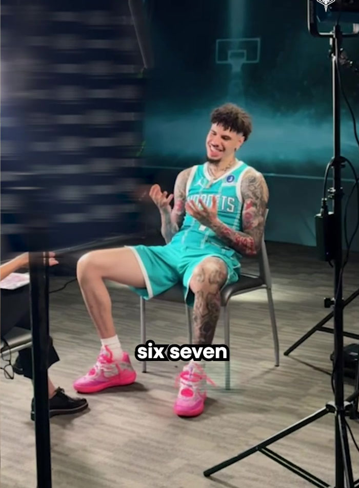Man in a basketball uniform sitting and laughing during an interview about overused slang words to be banished in 2026. Man in a basketball uniform sitting and laughing during an interview about overused slang words to be banished in 2026.