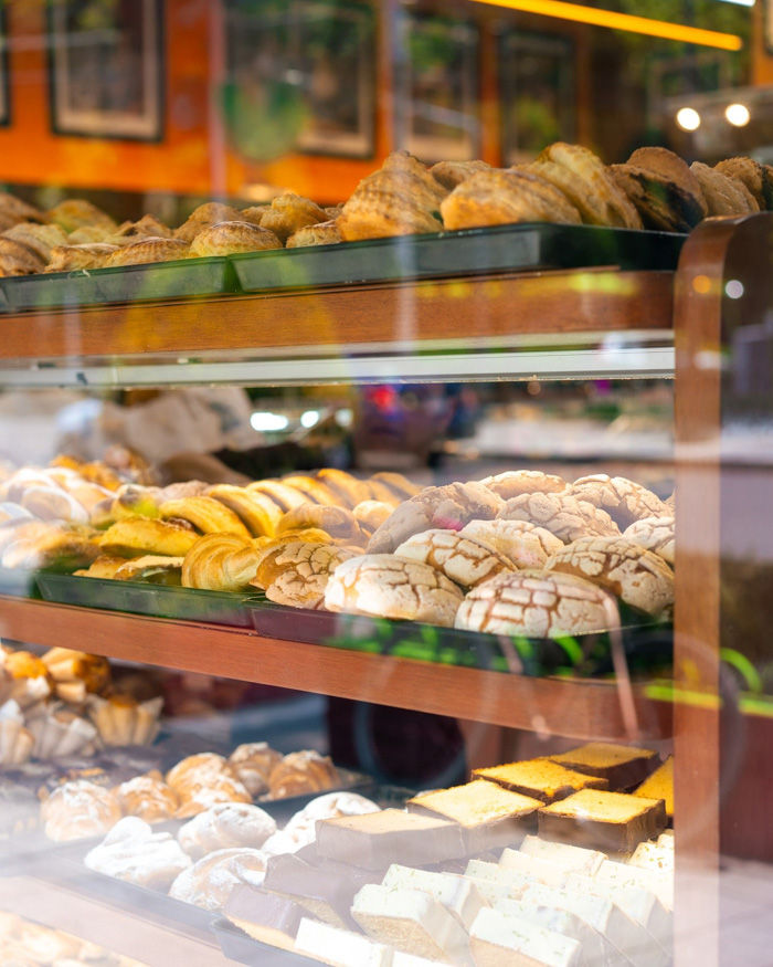Display of Mexican pan dulce and pastries in a bakery window, Fun Facts About Mexico.