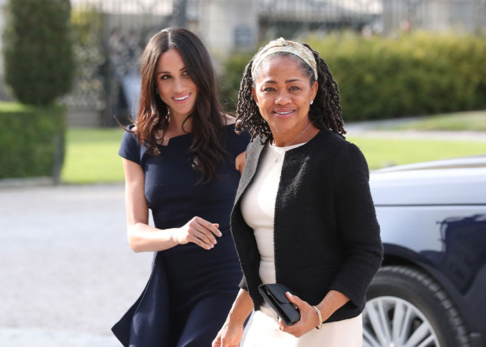 Meghan Markle and her mother Doria Ragland smiling outdoors, sparking alleged rift and wild theories discussion. Meghan Markle and her mother Doria Ragland smiling outdoors, sparking alleged rift and wild theories discussion.