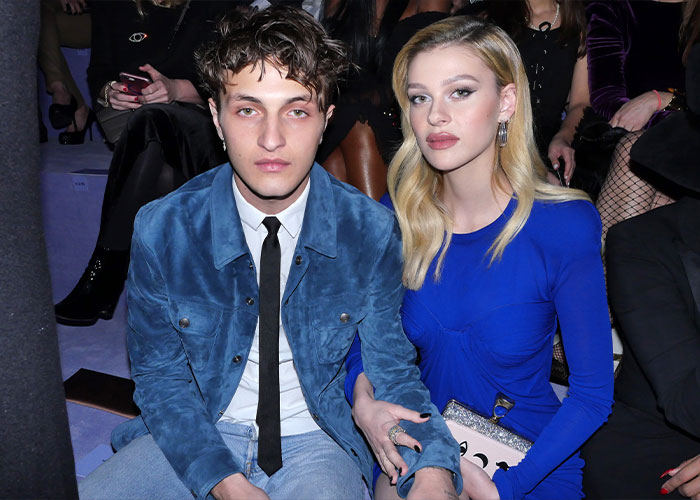 Young couple seated at an event, highlighting sister of Nicola Peltz's ex amid Brooklyn Beckham&rsquo;s scathing rant.