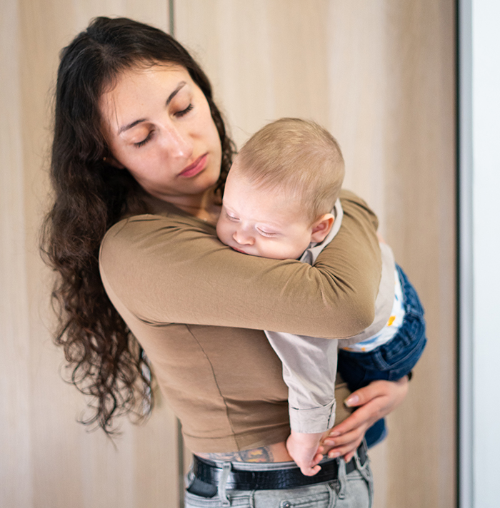 Worried woman holding baby, contemplating her sister who became a tradwife while keeping support fund secret. Worried woman holding baby, contemplating her sister who became a tradwife while keeping support fund secret.
