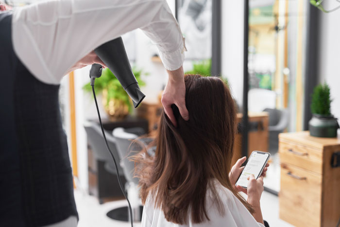 Woman at salon getting hair dried, illustrating bridezilla stress and family meeting tension during wedding planning. Woman at salon getting hair dried, illustrating bridezilla stress and family meeting tension during wedding planning.