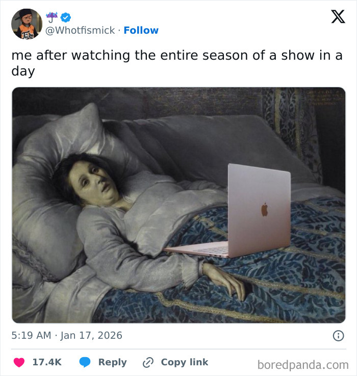 Person lying in bed with a laptop looking exhausted, a humorous moment from internet content in January.