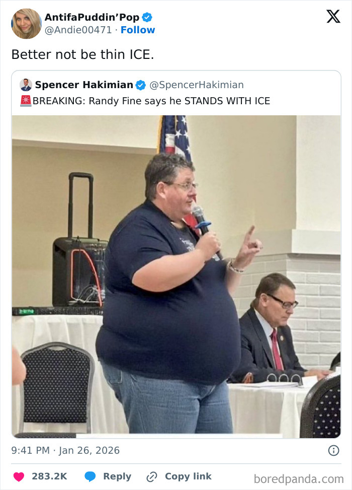 Man speaking into microphone at event with seated audience, humorous internet moment from January captured.