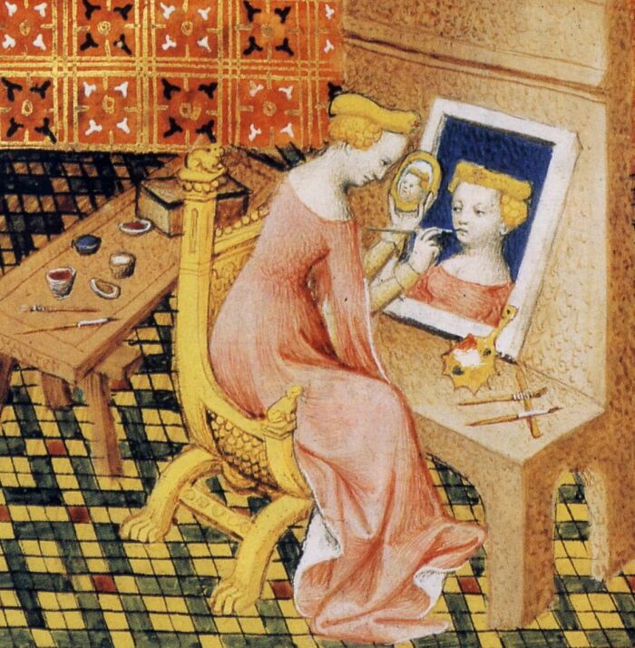 Medieval painting showing a woman applying makeup while looking into a mirror, perfect for meme captions and punchlines.