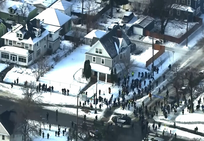 Crowd gathered outside a snowy residential neighborhood as family of mom slain by ICE agent makes comments. Crowd gathered outside a snowy residential neighborhood as family of mom slain by ICE agent makes comments.