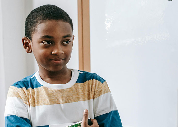 Boy with no filter sharing a family lore story with teachers in a casual classroom setting.