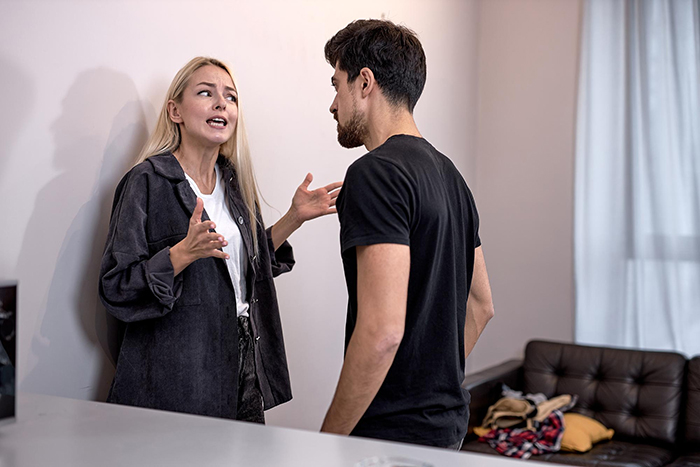 Couple having a tense argument indoors as wife decides to live life exactly like her husband, causing frustration.