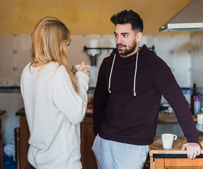 Worried woman talks to man in kitchen, reflecting concern about sister who became a tradwife and secret fund support. Worried woman talks to man in kitchen, reflecting concern about sister who became a tradwife and secret fund support.