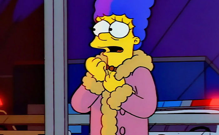 Anxious Marge Simpson in pink fur coat clutching hands near police lights - Simpsons 2026 predictions