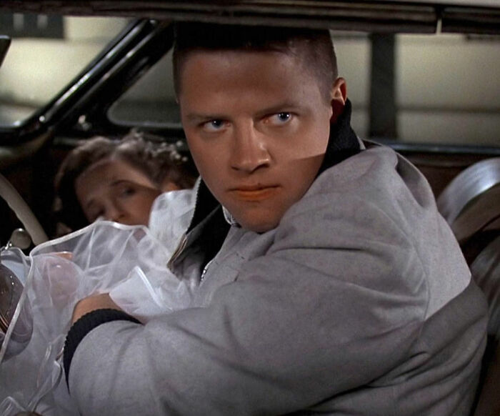 Close-up of an intense male actor in a car, illustrating behind-the-scenes insights from movie set workers on diva stars.