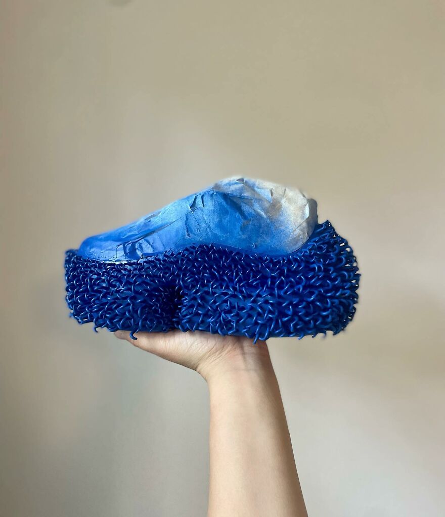 Hand holding a blue textured object inspired by biomimicry examples showing nature solving design challenges.