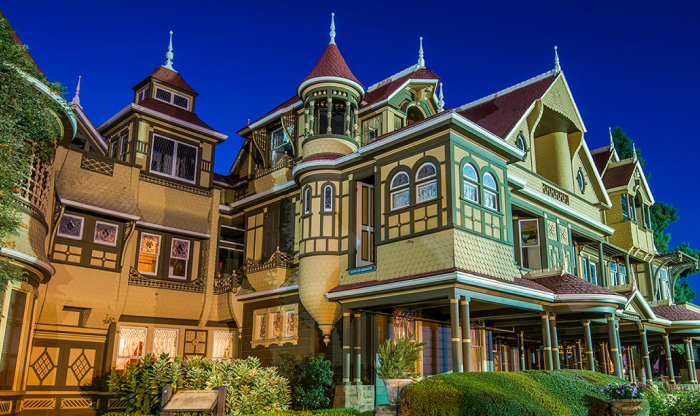 Victorian haunted mansion at night with intricate architecture and lights glowing, one of America’s most haunted places. Victorian haunted mansion at night with intricate architecture and lights glowing, one of America’s most haunted places.