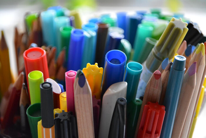 Close-up of colorful pens and pencils tightly packed, capturing a satisfying assortment of weird and iconic stationery situations.