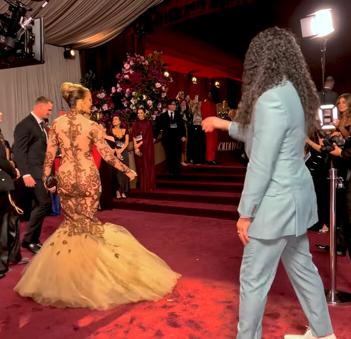 Jennifer Lopez in a detailed gown at the Golden Globes during a controversial moment sparking backlash for her interaction.