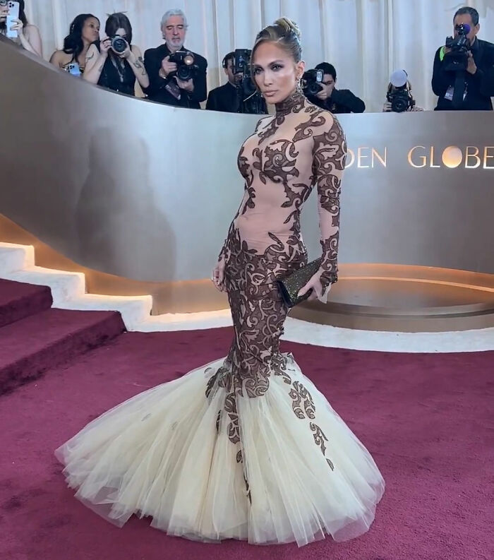 Jennifer Lopez wearing a detailed gown at the Golden Globes, amid backlash over her rude interaction reputation.
