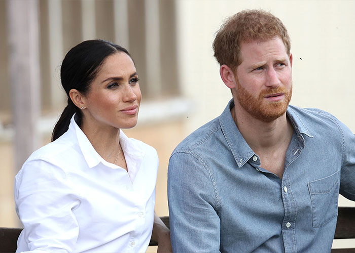 Meghan Markle and Prince Harry sitting together outdoors, highlighting Meghan Markle's family rift theories. Meghan Markle and Prince Harry sitting together outdoors, highlighting Meghan Markle's family rift theories.