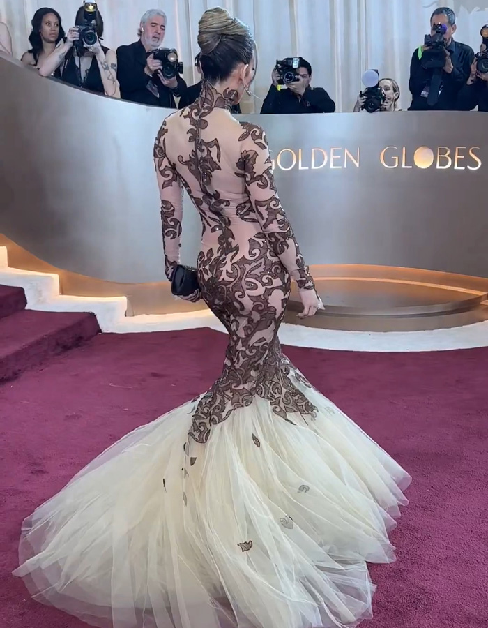 Jennifer Lopez in a sheer lace and tulle gown at the Golden Globes, sparking ageist backlash over her red carpet look.