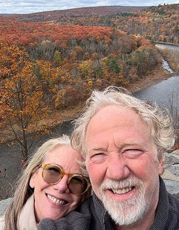 US Marshals join manhunt for West Wing star Timothy Busfield in autumn landscape selfie with a woman near a river.