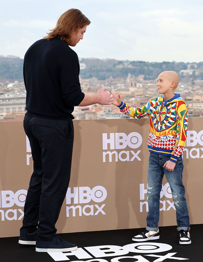 Peter Claffey's height compared to child star Dexter Sol Ansell during an outdoor HBO Max event interaction.
